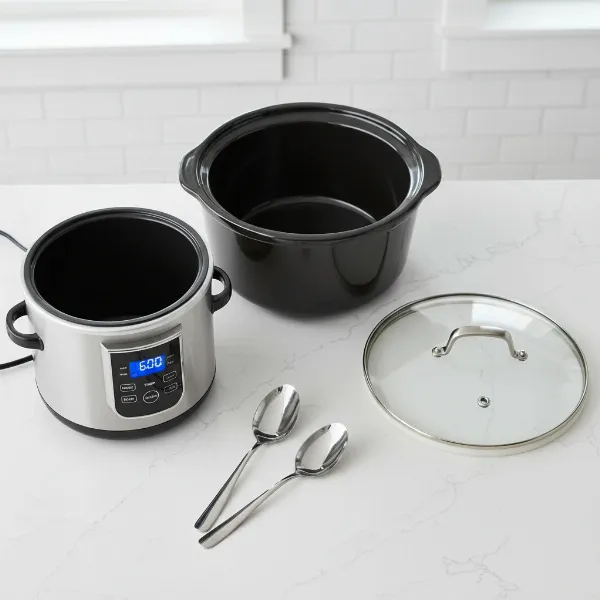 A disassembled slow cooker showing its main components, including a ceramic inner pot and heating base.